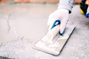 Contractor spreading freshly poured concrete