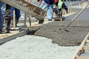 Concrete Being Poured and Spread for Sidewalk